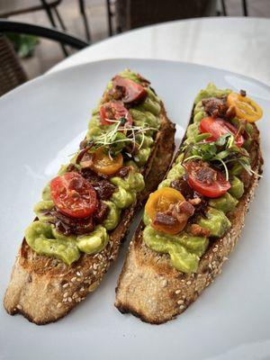 Love their avocado toast with onion jam, bacon, and tomatoes.