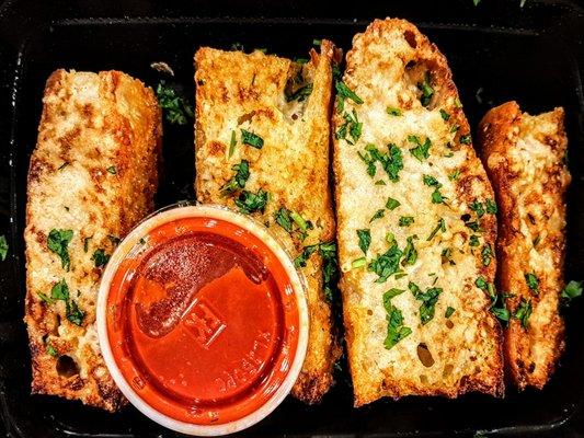 Garlic Bread: Four slices of focaccia slathered in garlic and parmesan. Served with marinara sauce $13.00