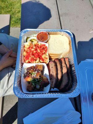 Brisket, spicy macaroni and cheese, pork burnt ends(?), and white bread.