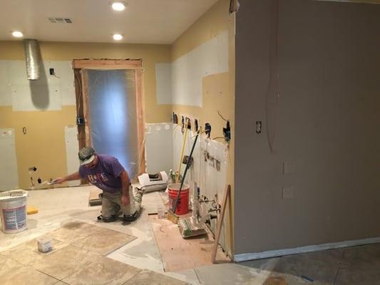 Don't mind the tile guy, the new electrical outlets continue.