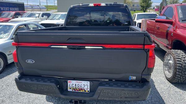 Black Ford F150 Lightning bed liner tailgate moments after re-install.