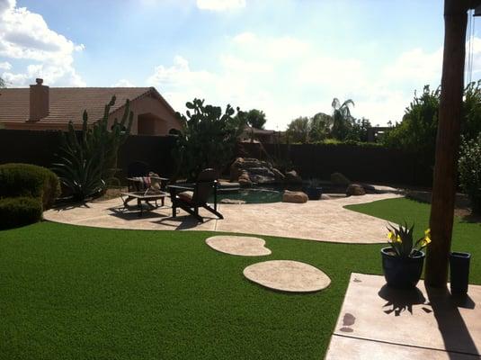 Turf installed around flagstone by TurfDIRECT.