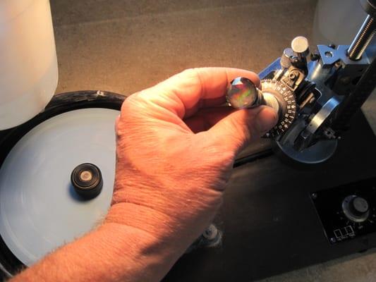 Polishing a large faceted opal.