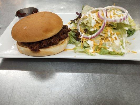 Pulled pork sandwich and side salad