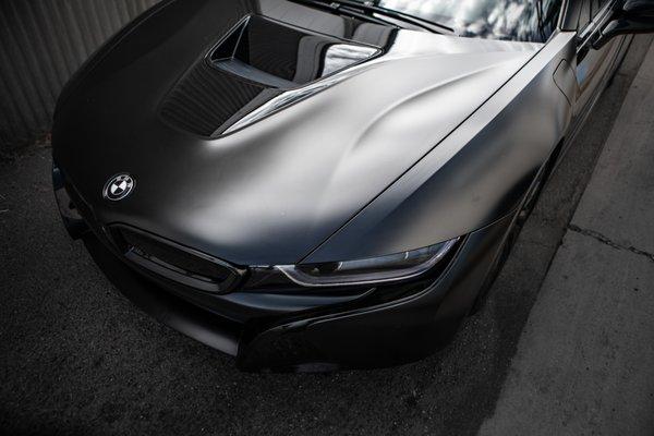 BMW i8 - Wrapped with an Aggressive Satin Black by Avery Custom Red Caliper Job Sleek Headlight Tint Lamination 5% Tint All around