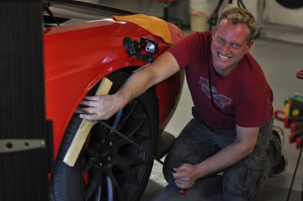 Working on a Hellcat with a fender dent.