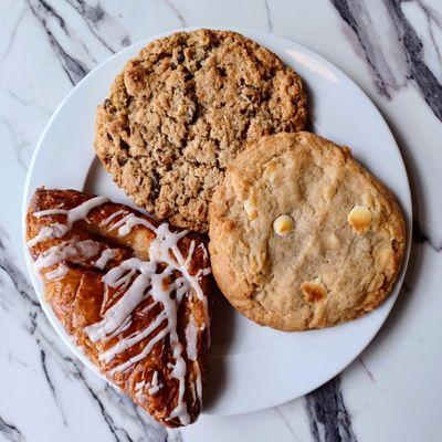 Oatmeal raisin cookie, white chocolate macadamia nut cookie, and an apple claw