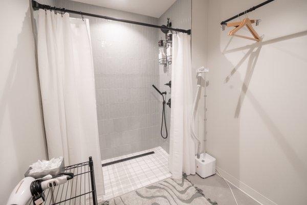 private showers with hangers, clothing steamer and hair dryer