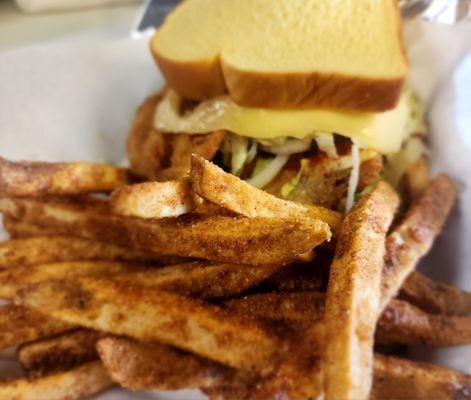 This is a fried whiting sandwich with our smoky & savory cheese, lettuce, and hot sauce served with our signature fries.