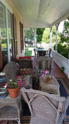 The east side of the porch with a table for eating towards the rear.