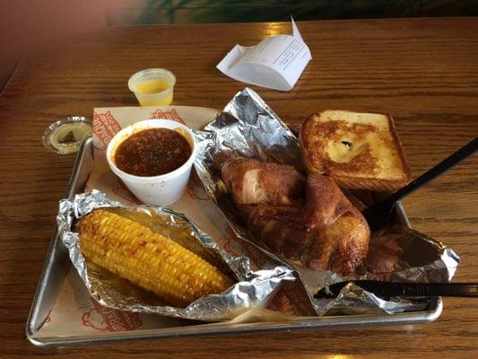 Half a chicken, baked beans, and fried, yes I said fried corn on the cob.