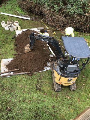 Digging out old pipe to install new pipe and connections