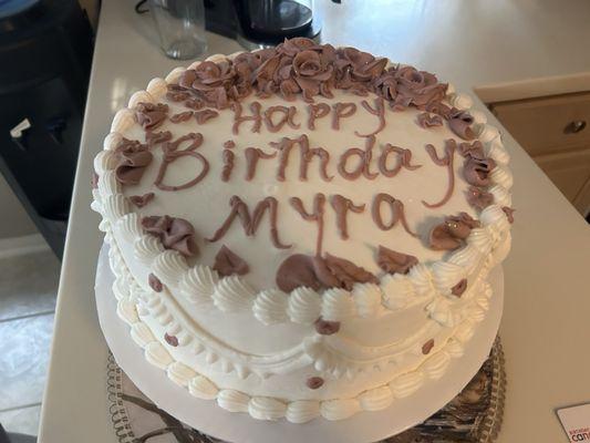 Birthday cake with rose gold decoration.