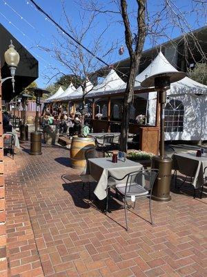 Outdoor seating area on curb, under awning, or under tents!