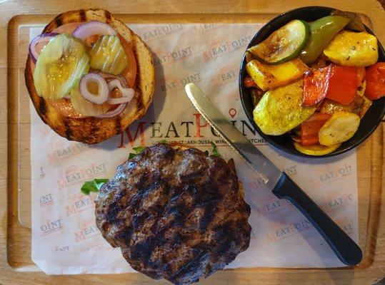 A 16oz burger with vegetables