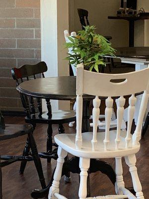 Restaurant seating with faux marijuana plant for decor.. cute idea that fits the restaurant's theme !