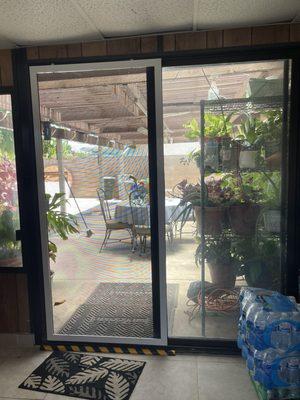 Repaired patio doors and installed a new screen.