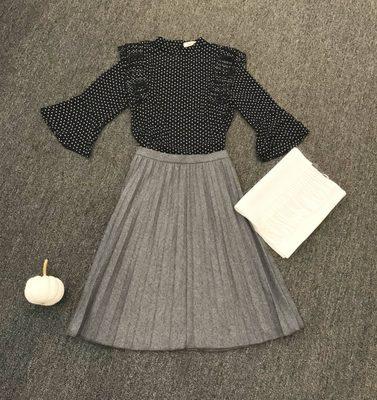 Pleated wool skirt and a flirty chiffon blouse in navy and white polka-dot