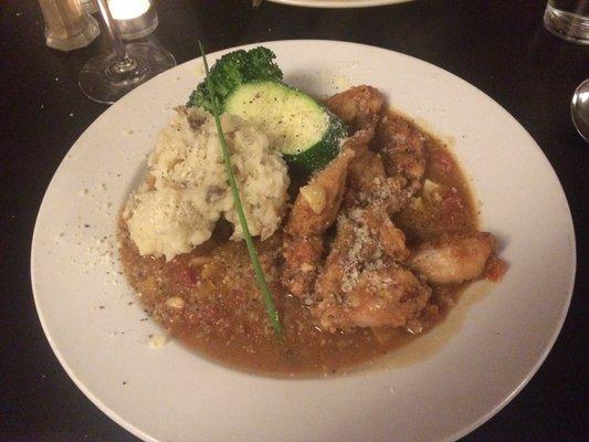 Frog Legs cooked in a red wine sauce and served with a side of Mashed Potatoes and Steamed Vegetables