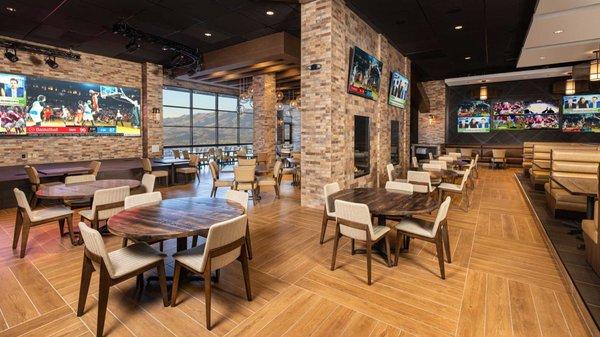 Chickie's & Pete's view dining area with stage, outdoor view and fire places.