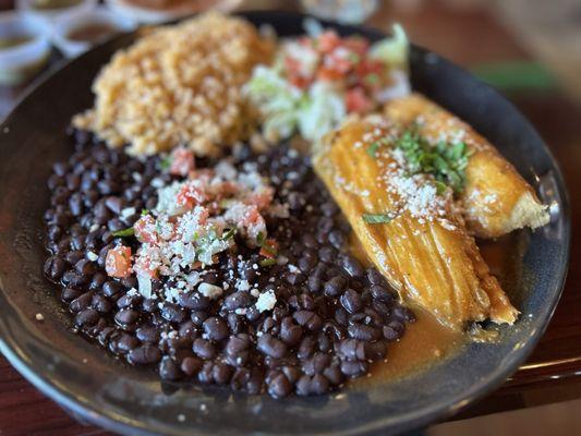 Chicken tamales meal with whole black beans