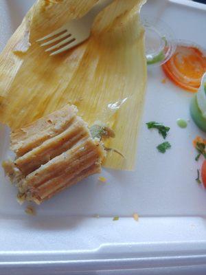 Plastic sticking out of tamale.