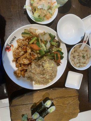 Lunch chicken, fried rice, soup, a salad, avocado sushi