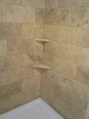 Busby condo shower travertine tile complete.