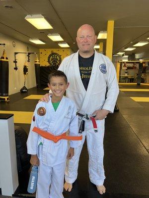 My son with Professor Bill after getting his orange belt!