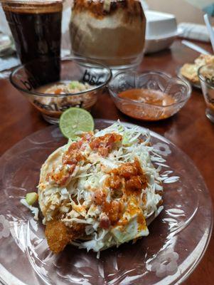 Fish taco smothered in slaw and salsa