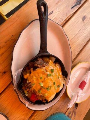 Charro Skillet: huge pieces of Carne Asada topped with hollandaise sauce and two eggs. Smoking hot and delicious!