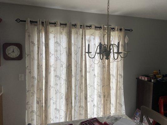 Hanging new curtains after a fresh paint job