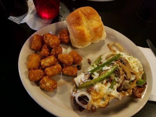 Smothered Steak with tots and a super yummy roll.