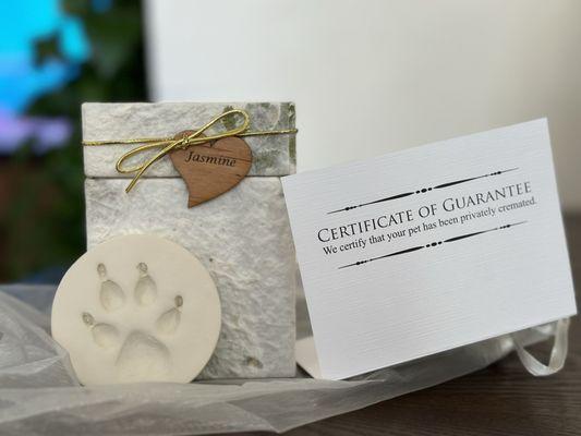 My dog's urn, and paw print and Certificate of private cremation, and condolence card from the clinic.