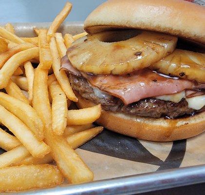 Hawaiian burger with fries.