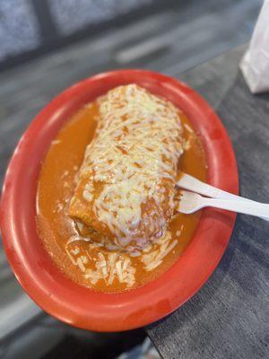 Regular burrito with red sauce and cheese on top