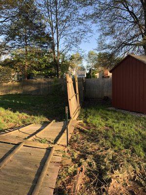 Fence that was hit and they just propped it up with a board, which blew down right after they left.