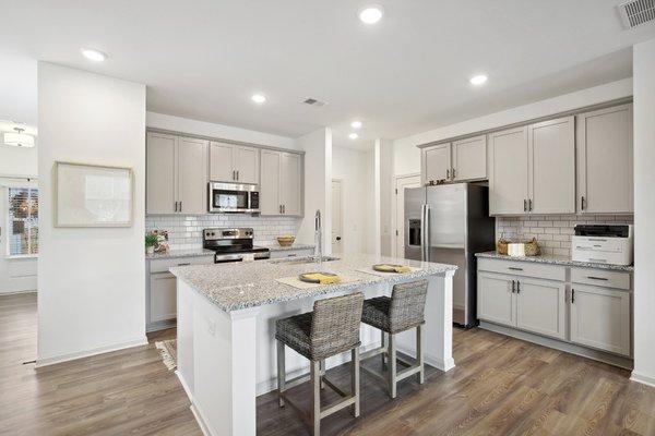 Spacious kitchen with ample storage and stainless steel appliances.