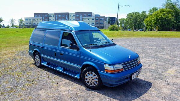 1994 Plymouth Grand Voyager with custom high top. Nick replaced the glass and it looks showroom new now.