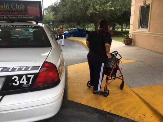 Parked in yellow zone on handicapped ramp in front of main door to the facility.