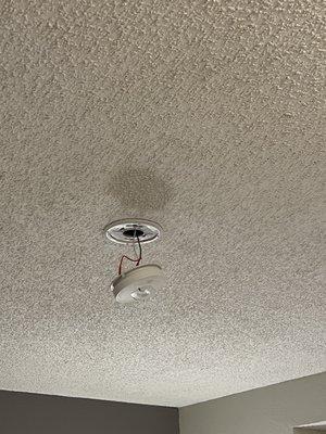 Fire alarm hanging from ceiling. I guess it works...?