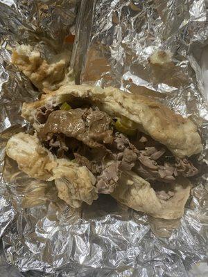 Sloppy Italian beef wet with mozzarella and hot peppers very good despite the fact it was sloppy