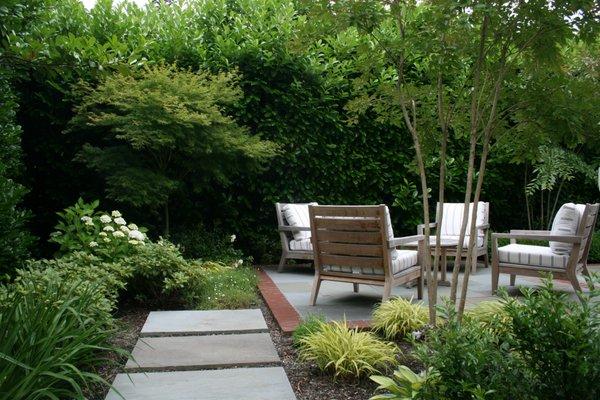 Bluestone Pavers Lead Guests to this Backyard Green Space.