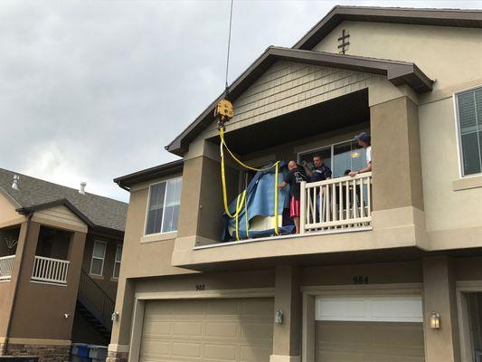 Removing a parlor grand off of a balcony.