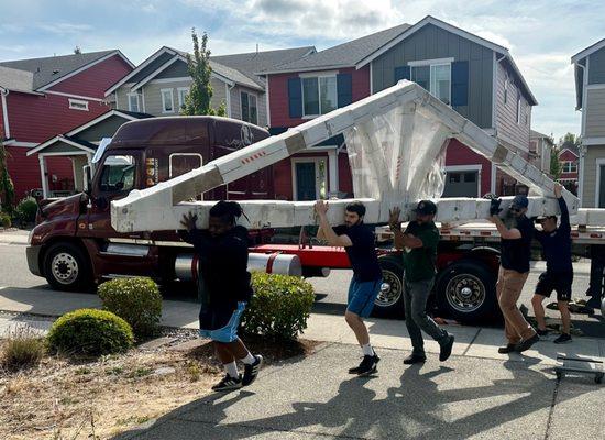 The CSM team working with the delivery crew to unload the largest/heaviest of the structure pieces.