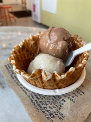 A scoop of Coffee with Sugar & Cream, and a scoop of Dairy Free Dark Chocolate Truffle in a waffle bowl.