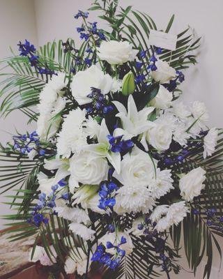 Funeral spray with pops of Kentucky blue