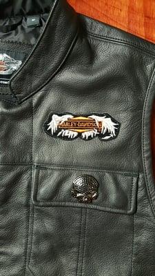 Another patch sewn poorly on leather. Off center and placed too high - patch was taped into the exact position it needed to be.