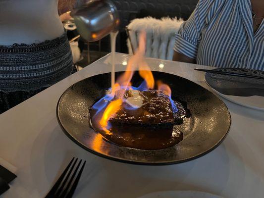 Flaming sticky toffee pudding