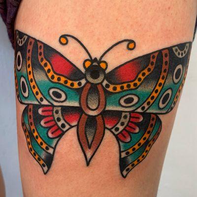 American traditional color butterfly tattoo on the thigh by Blake Aiken of Black Umbrella Tattoo and Art Gallery.